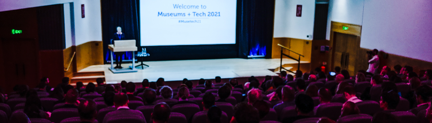 image of conference hall with 'welcome to museums+tech 2021' slide projected at the front